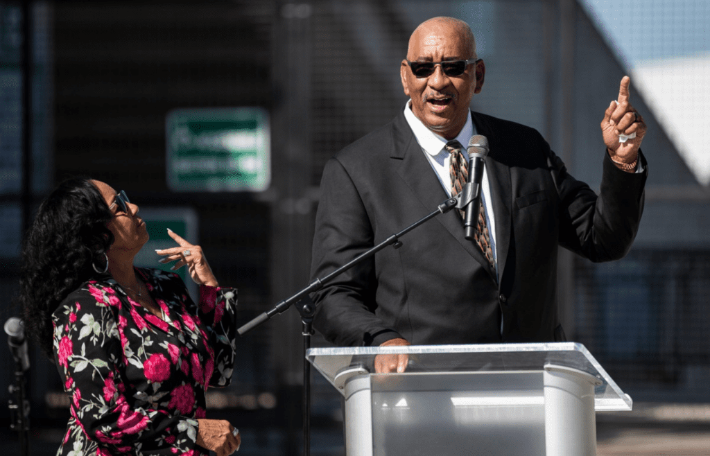 George Gervin speaks next to his wife Joyce King during the unveiling of George Gervin statue in front of EMU's George Gervin GameAbove Center in Ypsilanti on Thursday, August 31, 2023.