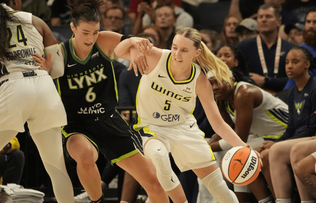 May 21, 2025; Minneapolis, Minnesota, USA; Dallas Wings guard Paige Bueckers (5) works around Minnesota Lynx forward Bridget Carleton (6) in the third quarter at Target Center. Mandatory Credit: Bruce Kluckhohn-Imagn Images