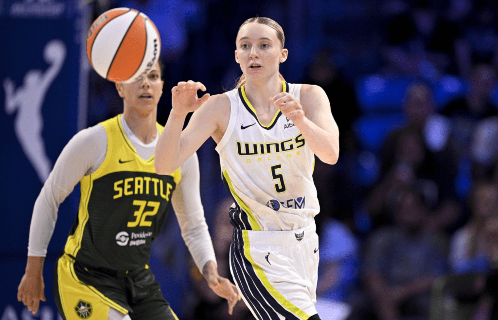 May 19, 2025; Arlington, Texas, USA; Dallas Wings guard Paige Bueckers (5) receives a pass as Seattle Storm forward Alysha Clark (32) looks on during the second half at College Park Center. Mandatory Credit: Jerome Miron-Imagn Images