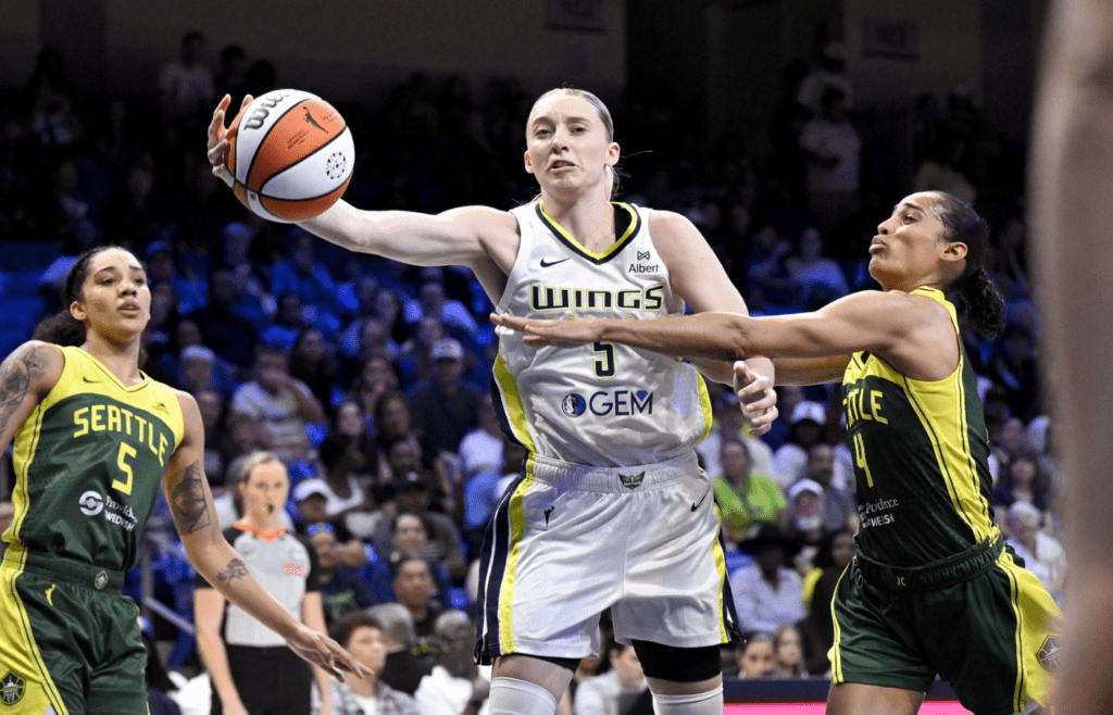 May 19, 2025; Arlington, Texas, USA; Dallas Wings guard Paige Bueckers (5) and Seattle Storm guard Skylar Diggins (4) battle for control of the ball during the first half at College Park Center. Mandatory Credit: Jerome Miron-Imagn Images