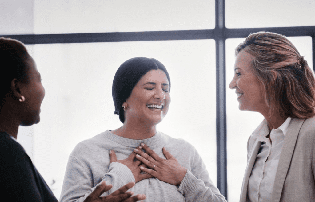 A person offering praise while the other looks uncomfortable
