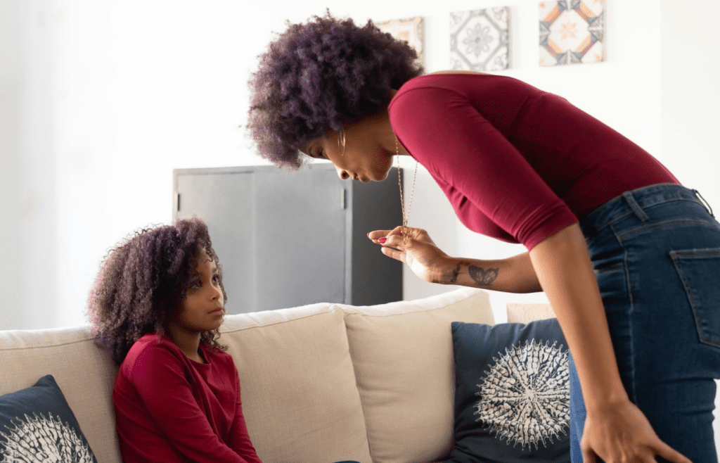 A parent figure talking seriously to someone younger