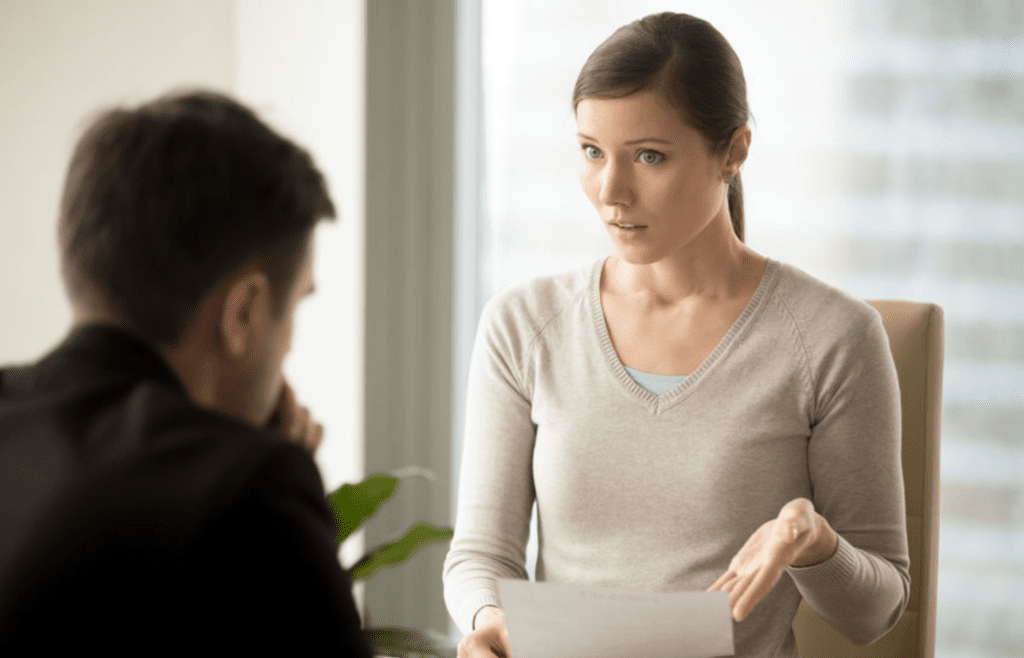 A person insisting while someone else looks unsure