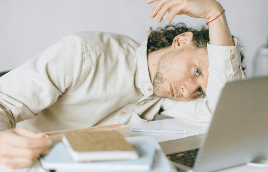 A tired office worker staring at a computer screen
