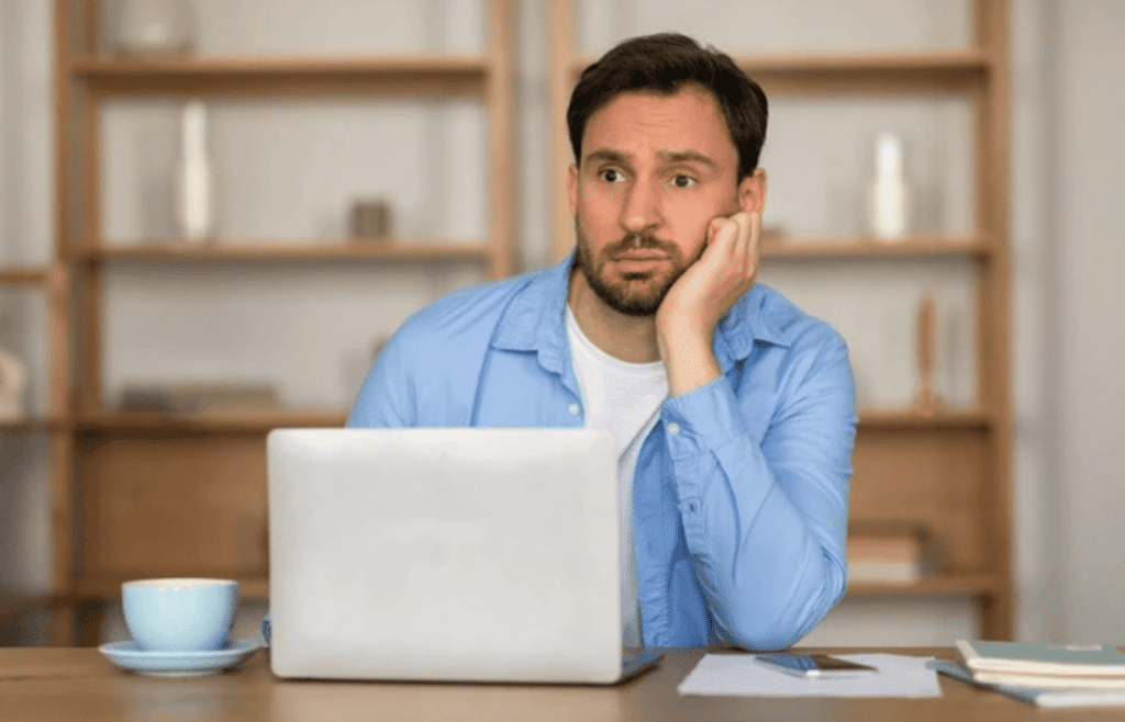 Someone staring blankly at a cubicle wall