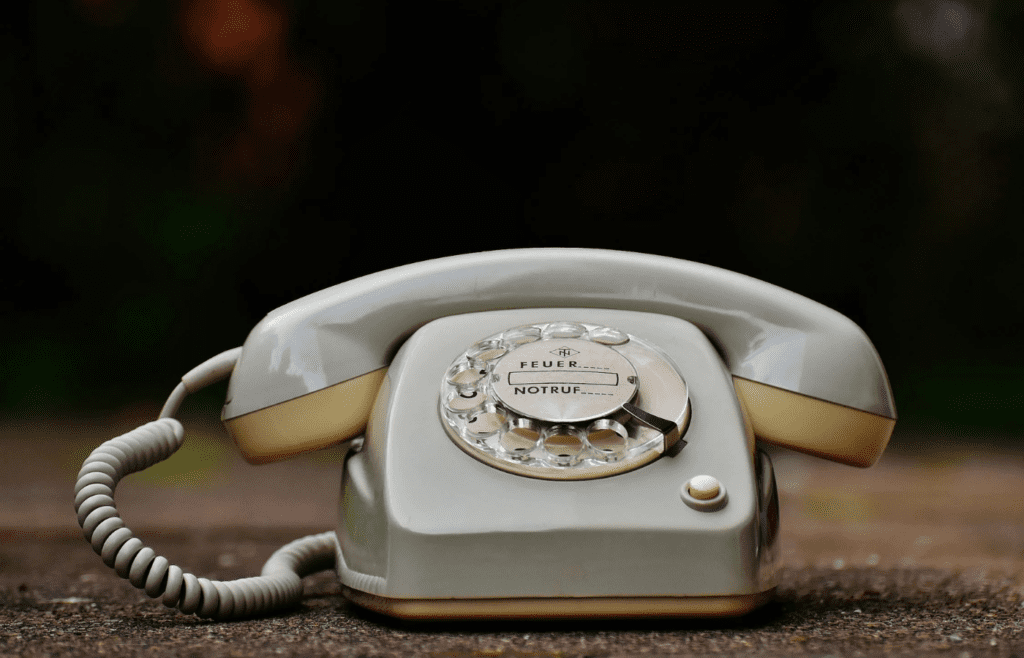 A rotary phone with a long cord.