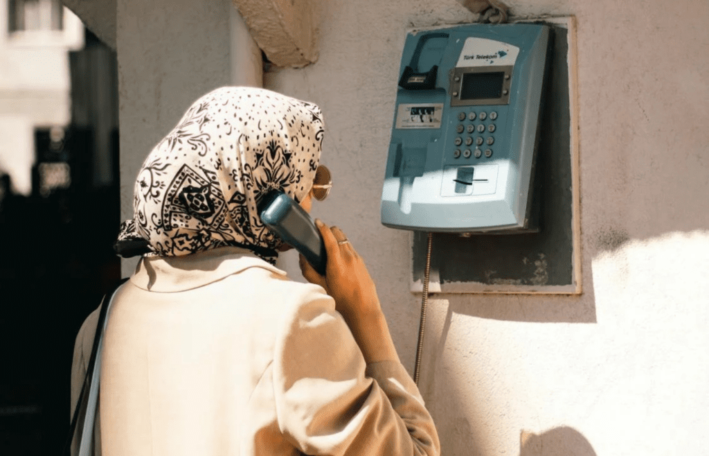 A public payphone on a sidewalk or wall