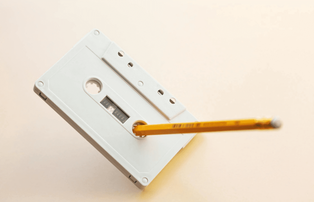 A pencil inserted into a tangled cassette tape
