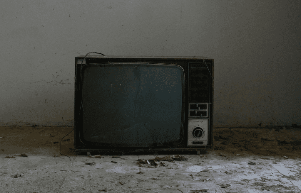 A worn VHS case next to a TV