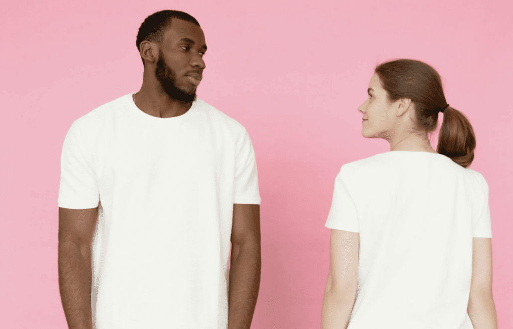 A person shrinking back as another looms or smirks