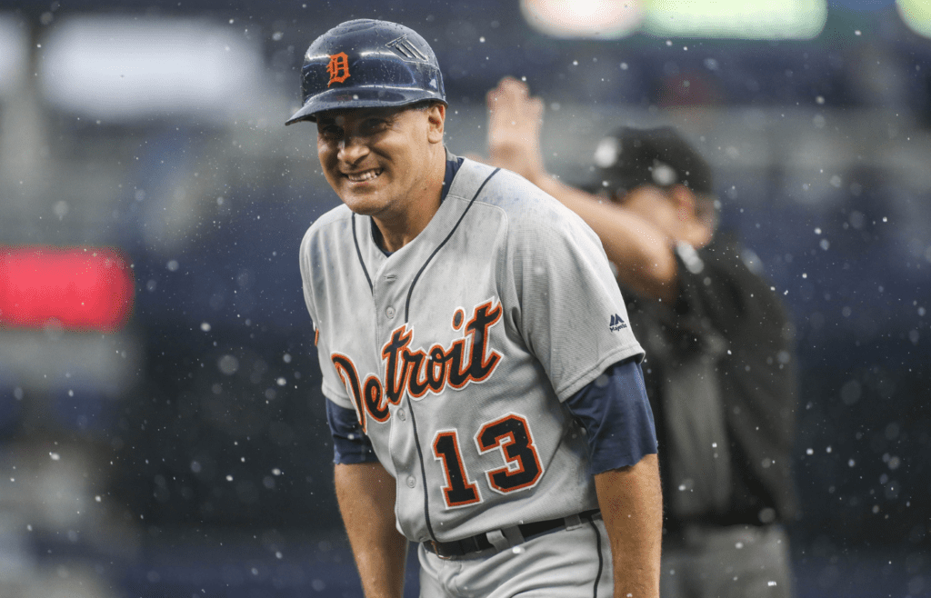 Aug 2, 2017; Bronx, NY, USA; Detroit Tigers first base coach Omar Vizquel (13) reacts in the rain in the seventh inning against the New York Yankees at Yankee Stadium. Mandatory Credit: Wendell Cruz-Imagn Images