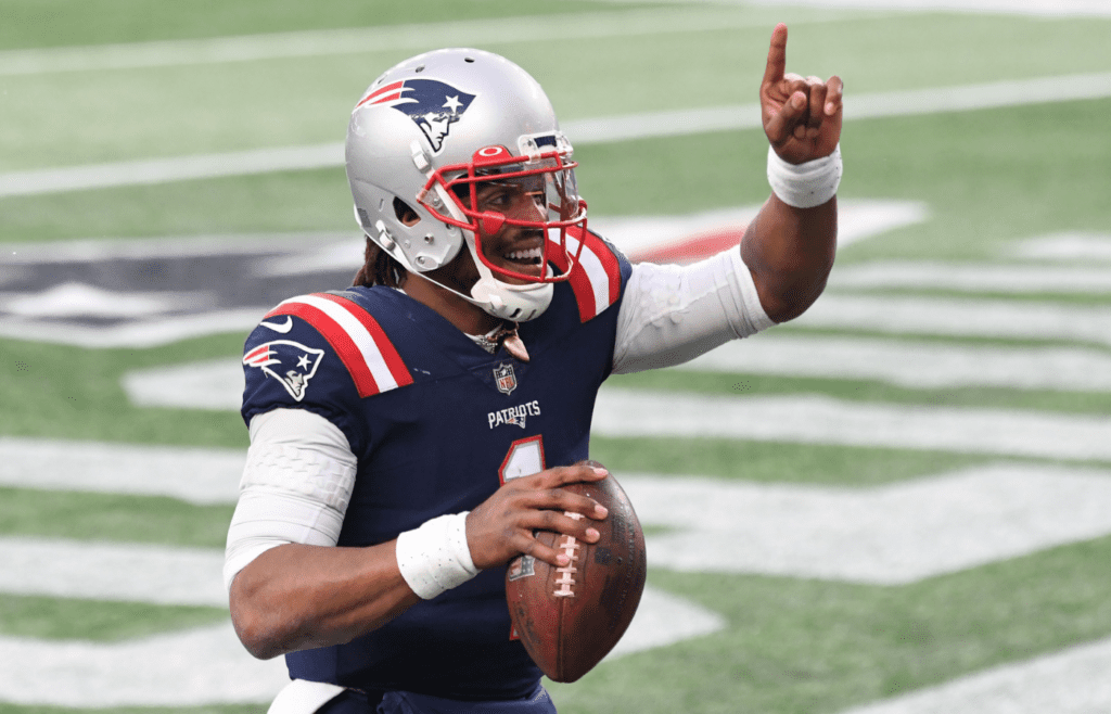 Jan 3, 2021; Foxborough, Massachusetts, USA; New England Patriots quarterback Cam Newton (1) celebrates after scoring a touchdown against the New York Jets during the third quarter at Gillette Stadium. Mandatory Credit: Brian Fluharty-Imagn Images