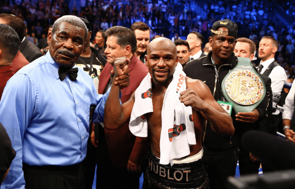 Aug 26, 2017; Las Vegas, NV, USA; Floyd Mayweather Jr. celebrates with referee Robert Byrd after defeating Conor McGregor (not pictured) in the tenth round during a boxing match at T-Mobile Arena. Mandatory Credit: Mark J. Rebilas-Imagn Images