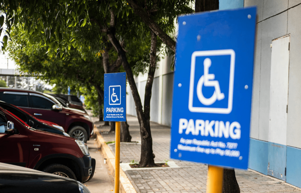 A stadium parking lot with signs and mobile payment fees