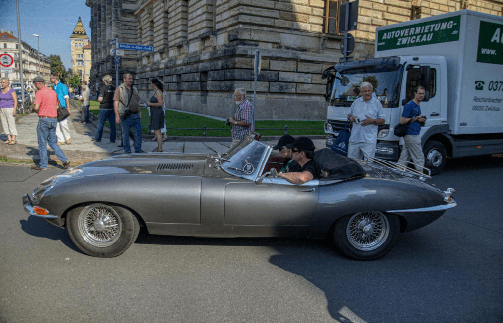 Man and Woman Riding a Vintage Car