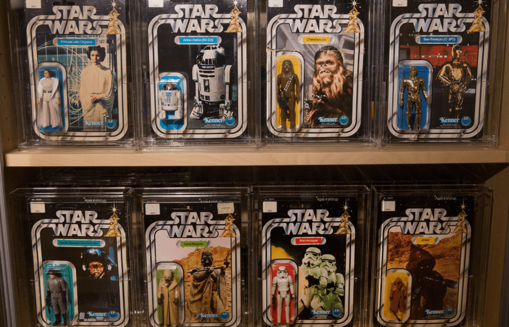 A collection of vintage Star Wars figures in their original packaging