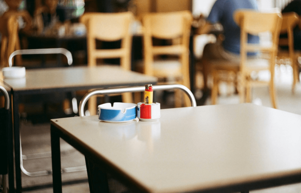 A restaurant with an ashtray on the table