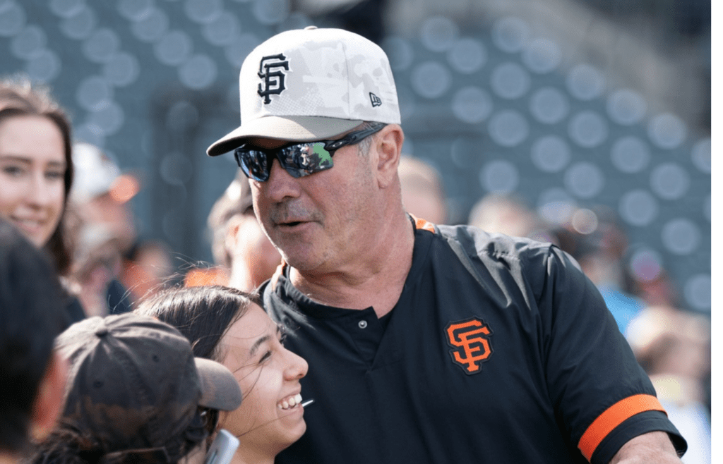 May 16, 2025; San Francisco, California, USA; San Francisco Giants great Will Clark, right, hugs a fan before a game against the Athletics at Oracle Park. Mandatory Credit: D. Ross Cameron-Imagn Images
