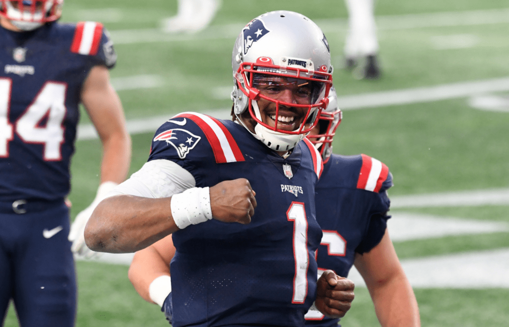 Jan 3, 2021; Foxborough, Massachusetts, USA; New England Patriots quarterback Cam Newton (1) celebrates after scoring a touchdown against the New York Jets during the third quarter at Gillette Stadium. Mandatory Credit: Brian Fluharty-Imagn Images