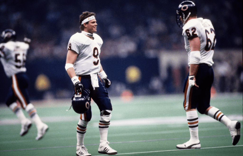 Jan 26, 1986; New Orleans, LA, USA: FILE PHOTO; Chicago Bears quarterback Jim McMahon (9) with guard Mark Bortz (62) on the field during Super Bowl XX against the New England Patriots at the Superdome. Chicago defeated New England 46-10. Mandatory Credit: Imagn Images