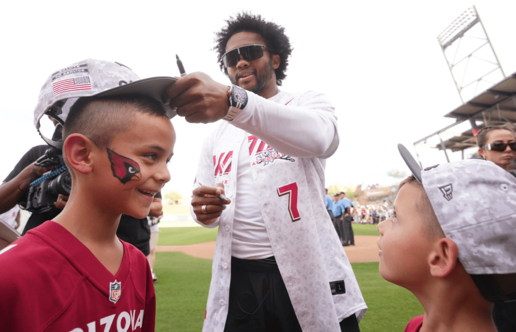 Arizona Cardinals quarterback Kyler Murray signs autographs for brothers Brody, 8, and Jaxson Quintero, 5, during his celebrity softball game at Salt River Fields in Scottsdale, on May 17, 2025