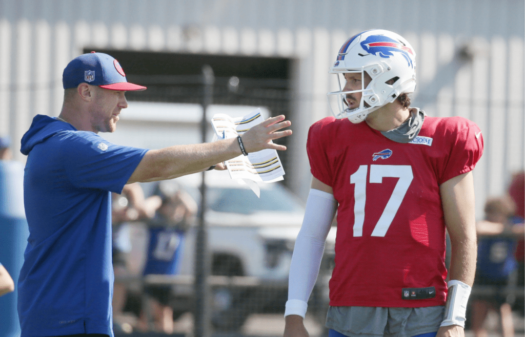 Bills quarterback Josh Allen talks with offensive coordinator Joe Brady between drills