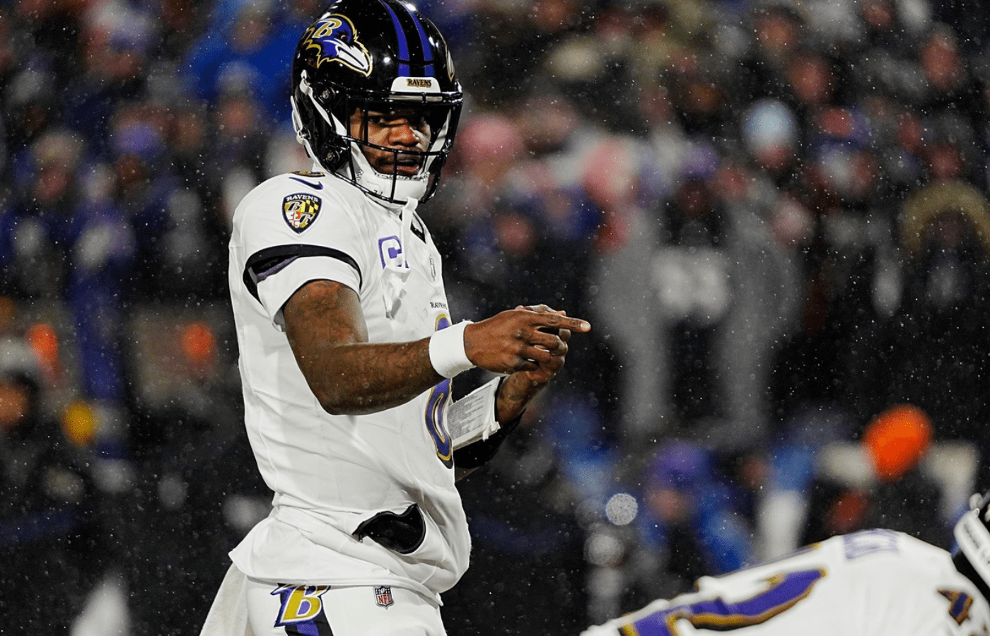 Baltimore Ravens quarterback Lamar Jackson directs his teammates before the snap