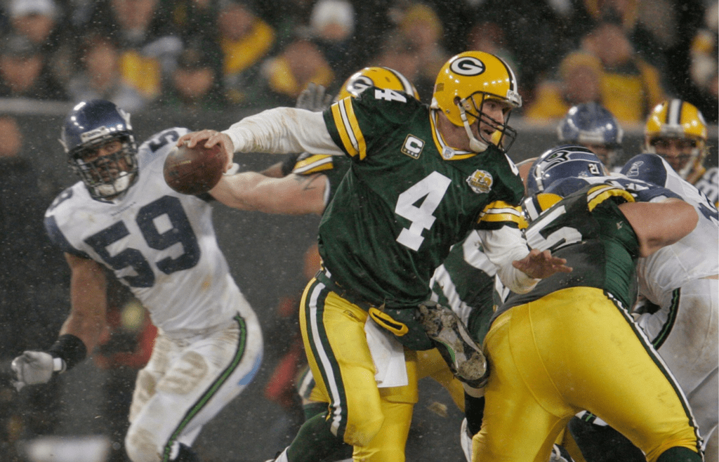 Green Bay Packers quarterback Brett Favre has to scramble but makes it outside to complete a shovel pass to Donald Lee during the second quarter of the Green Bay Packers and Seattle Seahawks NFL playoff game on Saturday, Jan. 12, 2008, at Lambeau Field