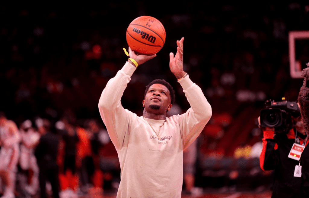 Nov 22, 2024; Houston, Texas, USA; Former Houston Texans wide receiver and Pro Football Hall of Famer Andre Johnson shoots the ceremonial first shot prior to the game between the Houston Rockets and the Portland Trailblazers at Toyota Center. Mandatory Credit: Erik Williams-Imagn Images