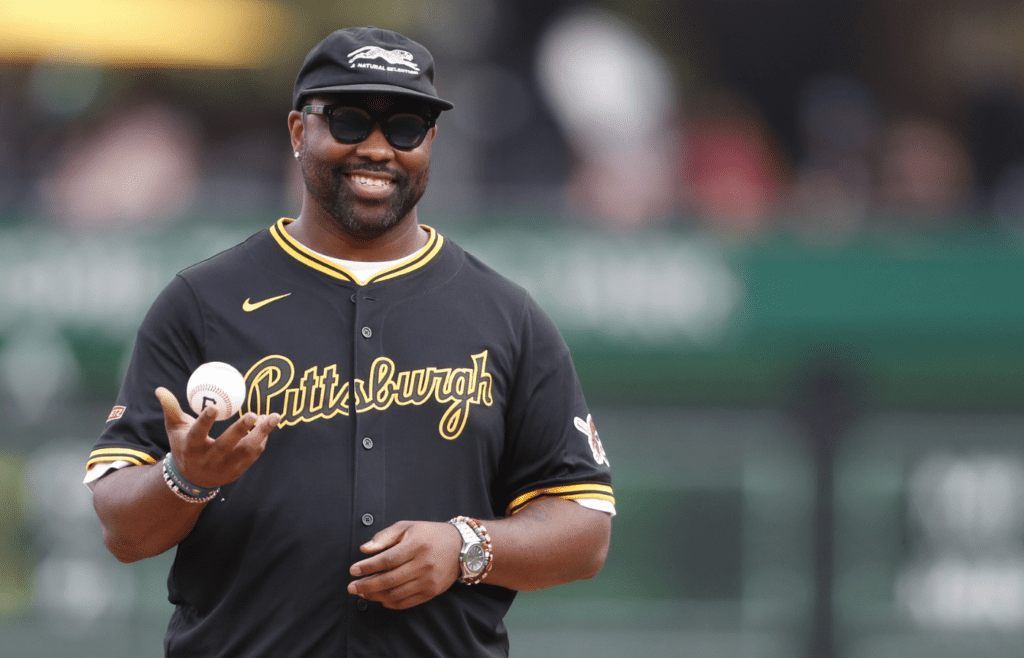 Jul 20, 2024; Pittsburgh, Pennsylvania, USA; NFL Hall of Fame defensive back Darrelle Revis throws out a ceremonial first pitch before a game between the Pittsburgh Pirates and the Philadelphia Phillies at PNC Park. Mandatory Credit: Charles LeClaire-Imagn Images