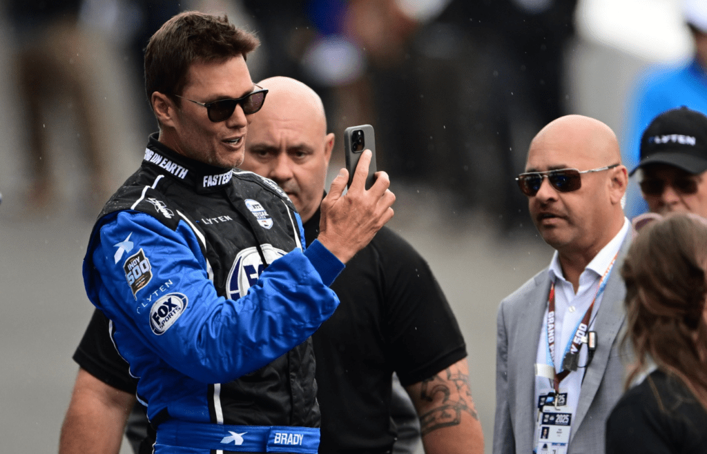 May 25, 2025; Indianapolis, Indiana, USA; Tom Brady looks on before the 109th Running of the Indianapolis 500 at Indianapolis Motor Speedway. Mandatory Credit: Marc Lebryk-Imagn Images