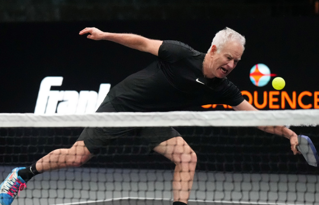 Feb 4, 2024; Hollywood, FL 33314, FL, USA; John McEnroe lunges for a return during Pickleball Slam 2 at Hard Rock Live at Seminole Hard Rock Hotel & Casino. Mandatory Credit: Jim Rassol-Imagn Images