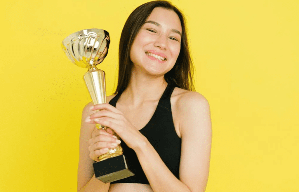 A person holding a trophy or pointing to themselves