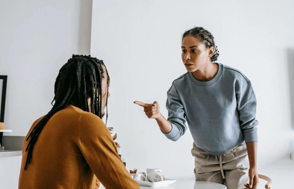 A person yelling or pointing during a heated exchange.