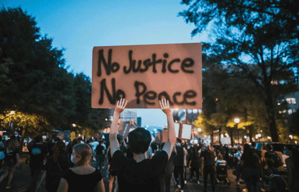 A person standing out in a crowd, arms raised