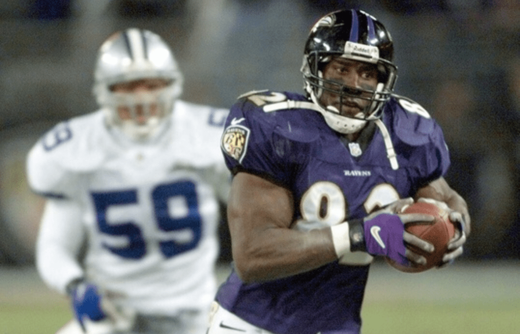 Ravens tight end Shannon Sharpe runs away from Cowboys linebacker Barron Wortham for a 59-yard touchdown pass reception in the first half on Nov. 19, 2000 in Baltimore