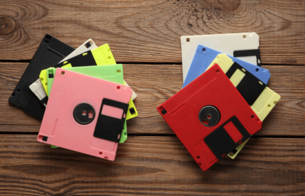 A collection of colorful floppy disks on a desk