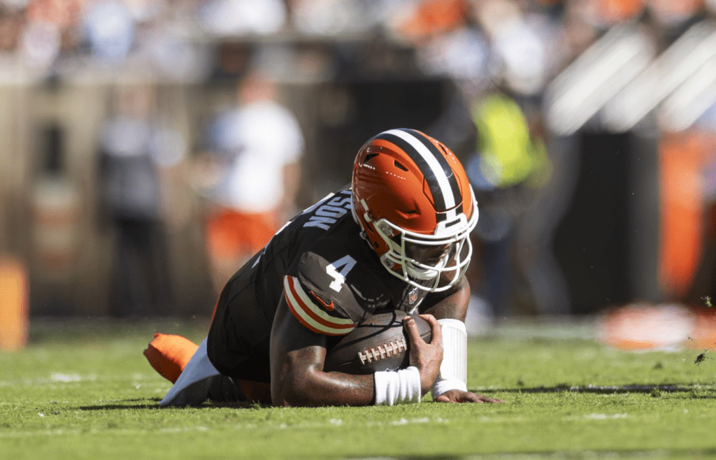 Oct 20, 2024; Cleveland, Ohio, USA; Cleveland Browns quarterback Deshaun Watson (4) falls to the ground with a torn Achilles during the second quarter against the Cincinnati Bengals at Huntington Bank Field. Mandatory Credit: Scott Galvin-Imagn Images