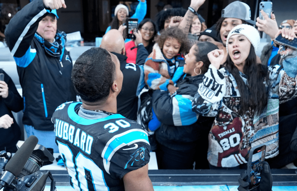 Dec 22, 2024; Charlotte, North Carolina, USA; Carolina Panthers running back Chuba Hubbard (30) celebreates with fans after scoring the game winning touchdown in overtime at Bank of America Stadium. Mandatory Credit: Bob Donnan-Imagn Images