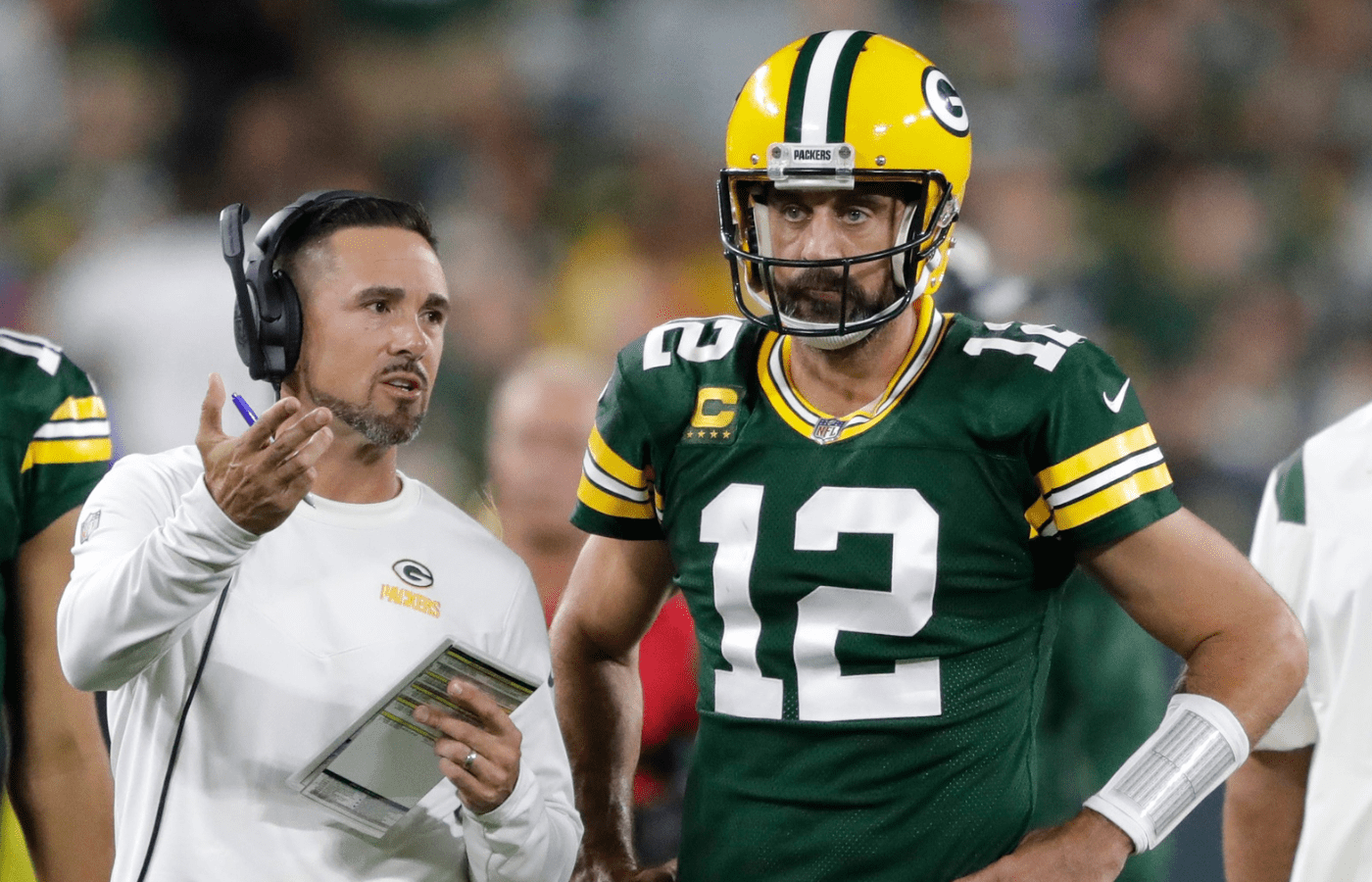 Green Bay Packers head coach Matt LaFleur talks with quarterback Aaron Rodgers (12) in between quarters against the Chicago Bears during their game on Sep 18, 2022, in Green Bay, Wisconsin.