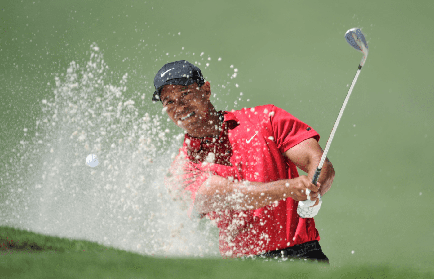 Tiger Woods first shot from the bunker at No 2 green. He had to hit from the sand a second time on April 11, 2010