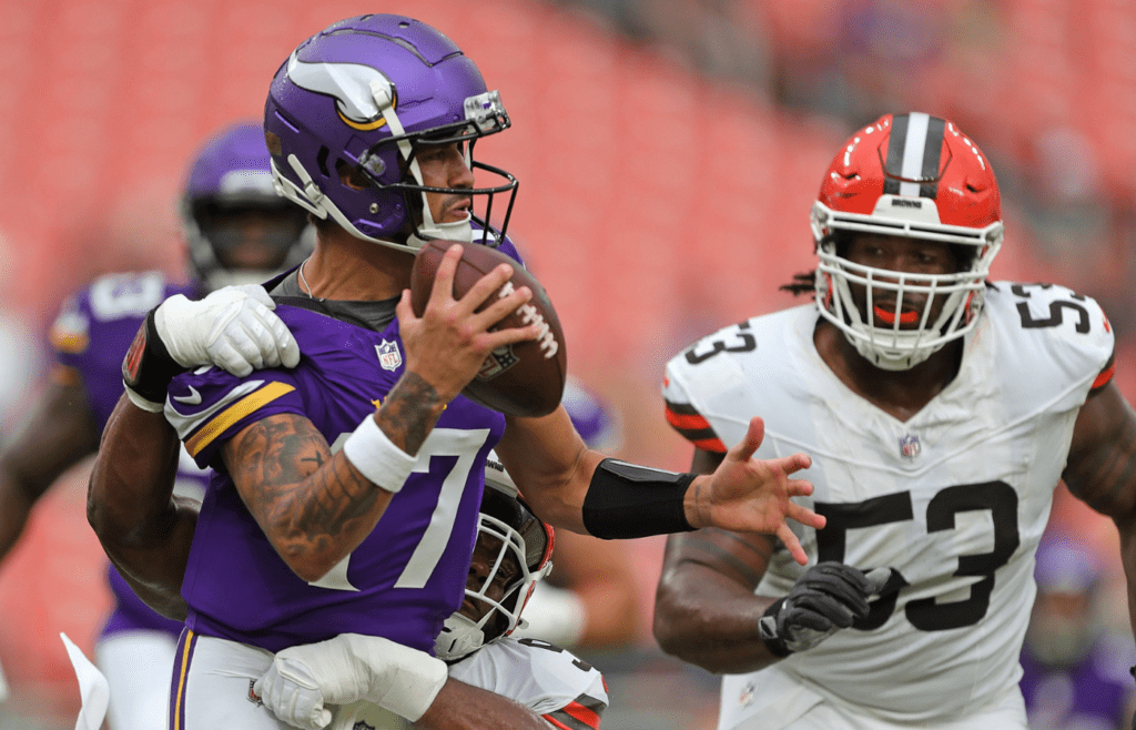 Minnesota Vikings quarterback Matt Corral (17) is brought down by Cleveland Browns defensive tackle Chris Williams (98) in the end zone during a preseason game on Aug. 17, 2024, in Cleveland, Ohio