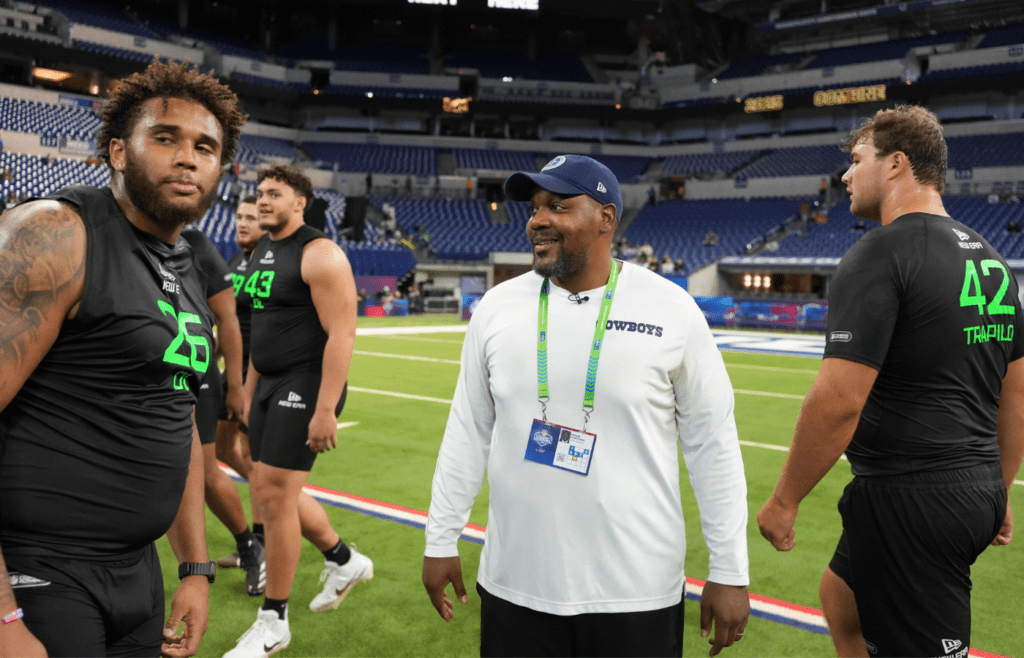 Mar 2, 2025; Indianapolis, IN, USA; Dallas Cowboys assistant offensive line coach Ramon Chinyoung (right) interacts with Purdue offensive lineman Marcus Mbow (OL26) and Boston College lineman Ozzy Trapilo (OL42) during the 2025 NFL Scouting Combine at Lucas Oil Stadium. Mandatory Credit: Kirby Lee-Imagn Images