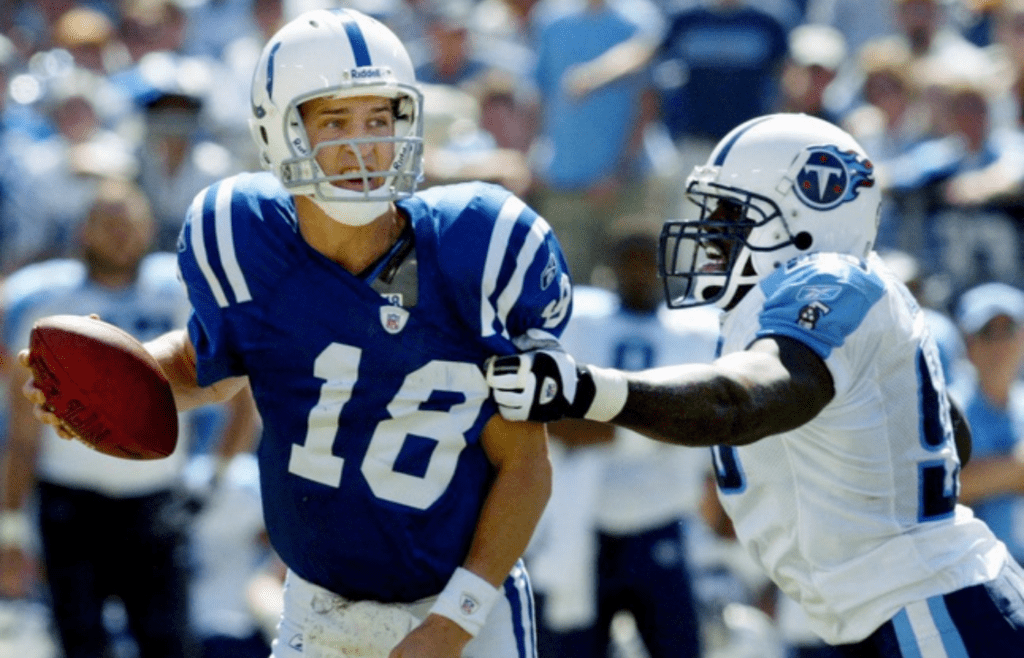 Indianapolis Colts quarterback Peyton Manning (18) attempts to break free from Tennessee Titans defensive end Antwan Odom (98) at the Adelphia Coliseum in Nashville on Sept. 19, 2004. The Titans lost 31-17 in their home opener.