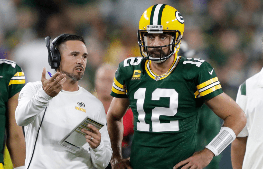Green Bay Packers head coach Matt LaFleur talks with quarterback Aaron Rodgers (12) in between quarters against the Chicago Bears during their game on Sep 18, 2022, in Green Bay, Wisconsin.