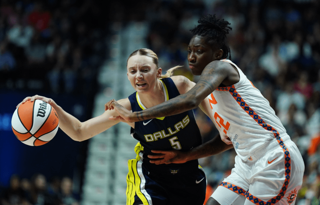 May 27, 2025; Uncasville, Connecticut, USA; Dallas Wings guard Paige Bueckers (5) drives the ball against Connecticut Sun guard Saniya Rivers (22) in the first half at Mohegan Sun Arena. Mandatory Credit: David Butler II-Imagn Images