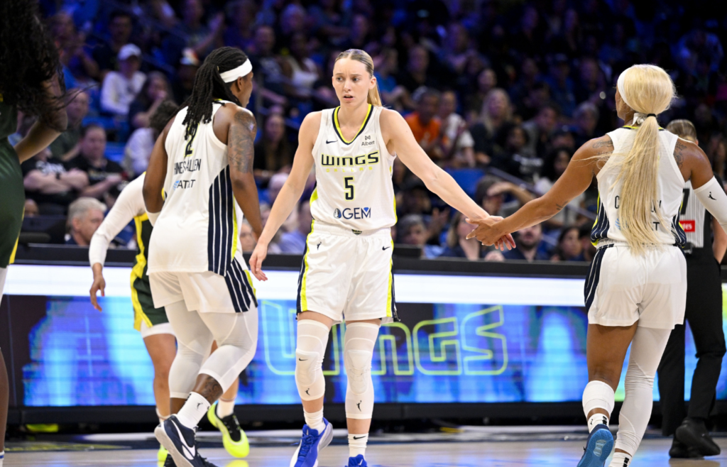 May 19, 2025; Arlington, Texas, USA; Dallas Wings forward Myisha Hines-Allen (2) and guard Paige Bueckers (5) and guard DiJonai Carrington (21) in action during the game between the Dallas Wings and the Seattle Storm at College Park Center. Mandatory Credit: Jerome Miron-Imagn Images