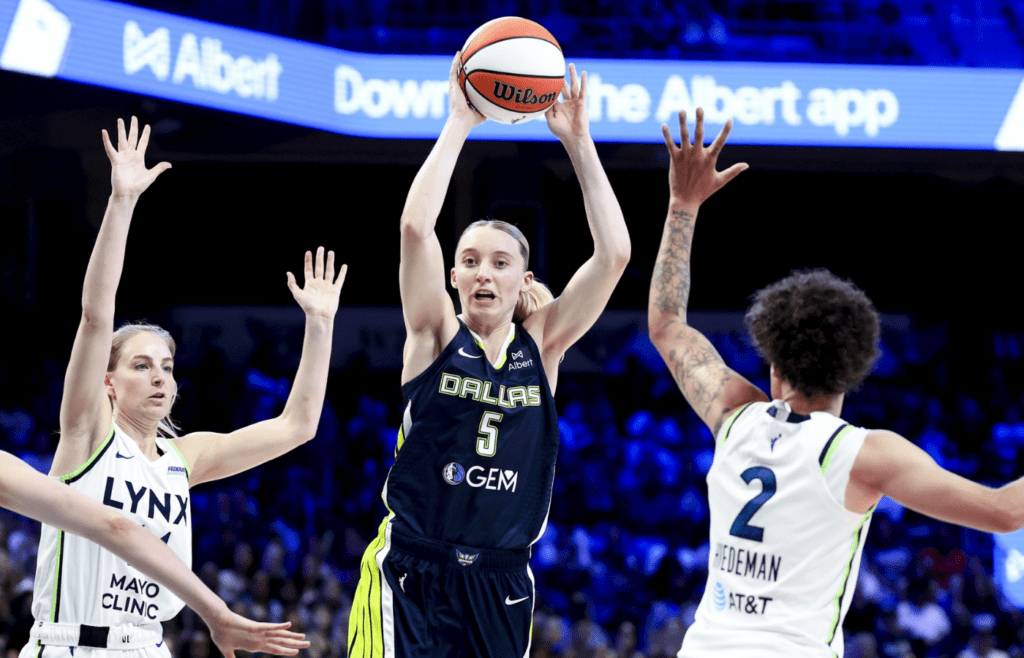 May 16, 2025; Arlington, Texas, USA; Dallas Wings guard Paige Bueckers (5) passes over Minnesota Lynx guard Natisha Hiedeman (2) during the second half at College Park Center. Mandatory Credit: Kevin Jairaj-Imagn Images