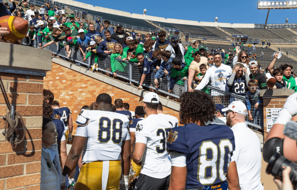 Apr 12, 2025; Notre Dame, IN, USA; Notre Dame players walk off the field as fans cheer for them during the Blue-Gold game at Notre Dame Stadium. Mandatory Credit: Michael Caterina-Imagn Images