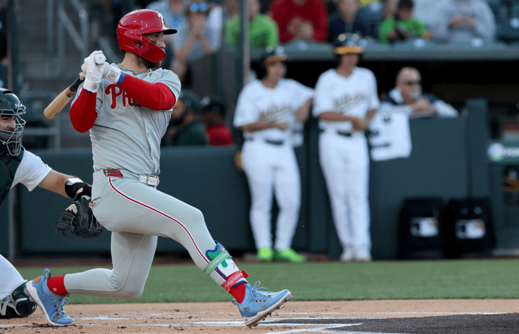 May 24, 2025; West Sacramento, California, USA; Philadelphia Phillies first baseman Bryce Harper (3) hits an RBI single against the Athletics during the first inning at Sutter Health Park. Mandatory Credit: Dennis Lee-Imagn Images
